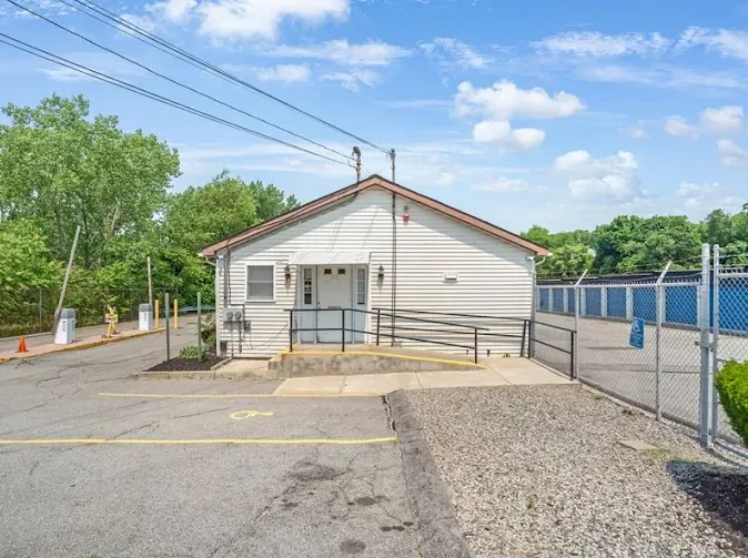 Small rental office at Storage Star Self-Storage in Providence at 550 Veazie ST, with an accessibility ramp next to a gated entrance and exterior drive-up storage units