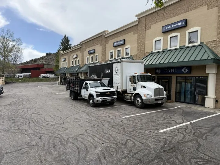 Row of commercial storage units in Avon, CO, at Storage Star on Nottingham Rd, featuring various businesses and a paved parking lot