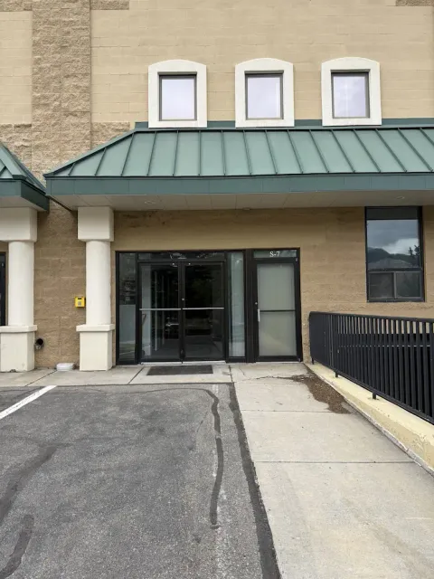 Entrance to the office at Storage Star Self-Storage in Avon, CO, at 910 Nottingham Rd, featuring a tan brick building with glass doors and a green metal awning