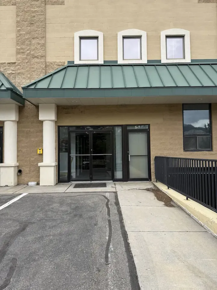 Entrance to the office at Storage Star Self-Storage in Avon, CO, at 910 Nottingham Rd, featuring a tan brick building with glass doors and a green metal awning