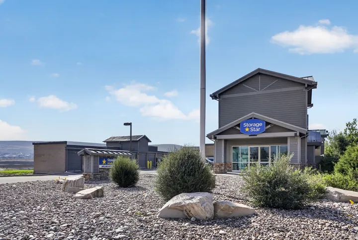 Gray-sided facility office at Storage Star Self-Storage in Park City, UT, with glass doors and a blue Storage Star sign under a clear sky