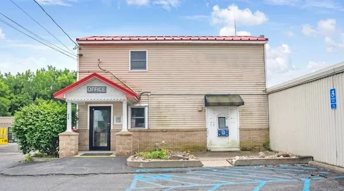 Two-story rental office at Storage Star Self-Storage in Cohoes, NY, with tan siding and a red roof
