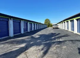 A wide drive aisle with various outdoor drive-up storage units in Marco Island at E Elkcam Circle