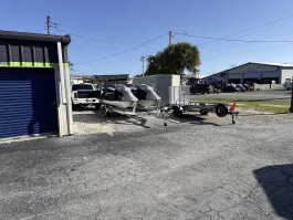 Outdoor vehicle storage in Marco Island on E Elkcam Cir, featuring various trailers and jet skis