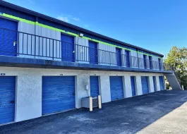 A wide driveway featuring a mix of upper-level walk-up units and ground-level drive-up storage in Marco Island on E Elkcam Circle
