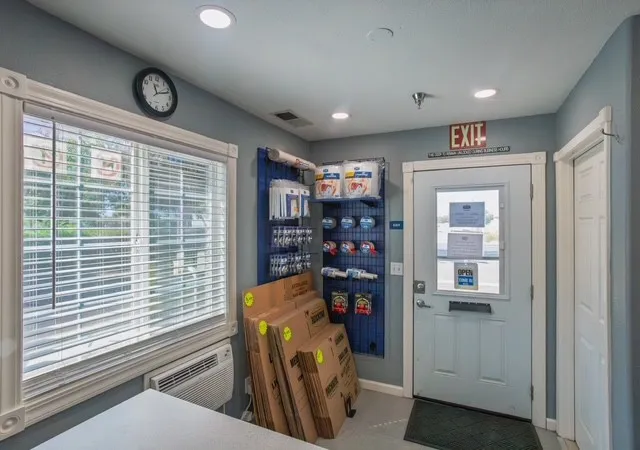 Interior Storage Star office lobby in Woodland, CA, featuring moving boxes and supplies for sale next to an exit door