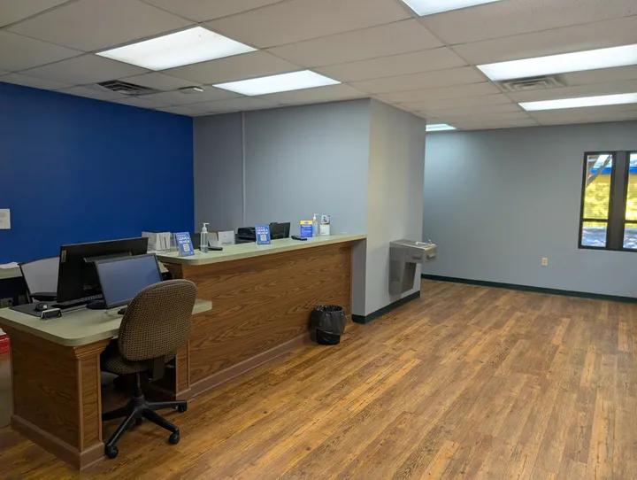 Inside the rental office at Storage Star Self-Storage in Glen Allen, featuring a long desk with computer monitors and a drinking fountain to the side