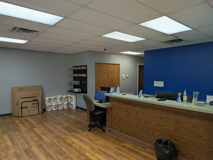 Inside the rental office at Storage Star Self-Storage in Glen Allen, featuring a long desk with computer monitors and moving supplies in the corner