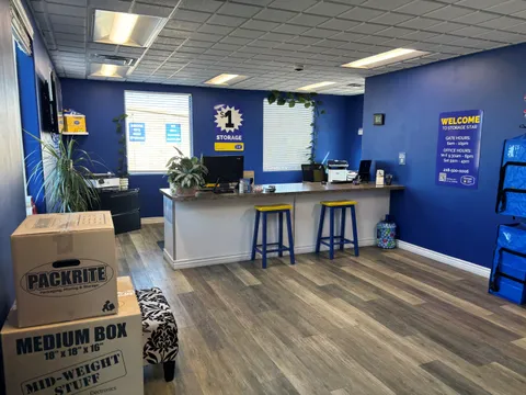 Indoor rental office with a service counter, blue walls, stools, and stacked moving boxes at Storage Star Self-Storage in Twin Falls on Grandview Dr