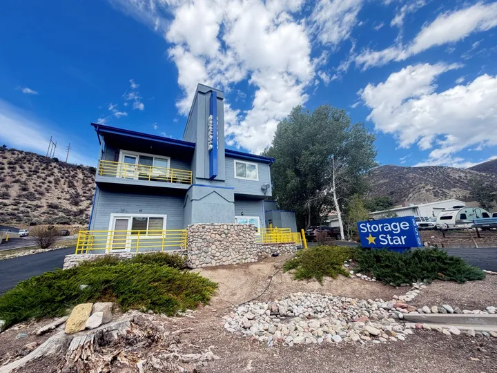 Exterior of a gray and blue Storage Star office building at 850 Nottingham Rd with yellow railings, stone accents, and a blue monument sign