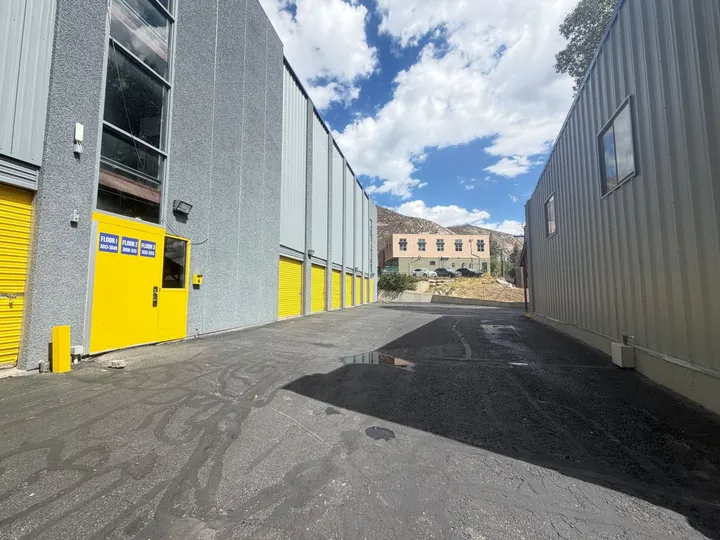 Wide aisles and convenient outdoor drive-up storage units in Avon, CO, with yellow roll-up doors