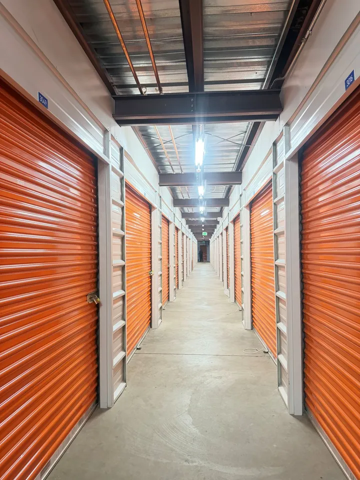 Hallway of indoor storage units in Avon on Nottingham Rd at the Storage Star storage facility, featuring red roll-up doors