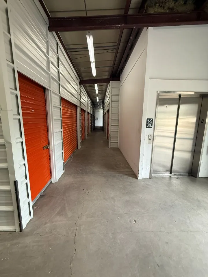 A hallway with an elevator and several indoor storage units in Avon at 850 Nottingham Rd
