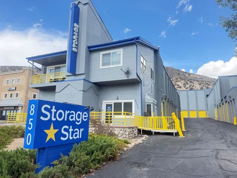 A Storage Star self-storage in Avon at 850 Nottingham Rd, featuring a blue monument sign in front of a blue and gray rental office with yellow railings and drive-up storage units in the background