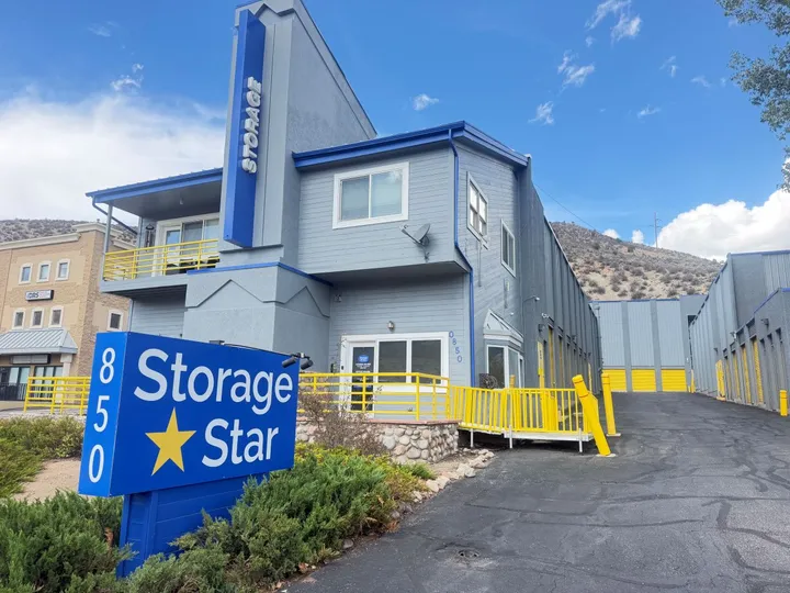 A Storage Star self-storage in Avon at 850 Nottingham Rd, featuring a blue monument sign in front of a blue and gray rental office with yellow railings and drive-up storage units in the background