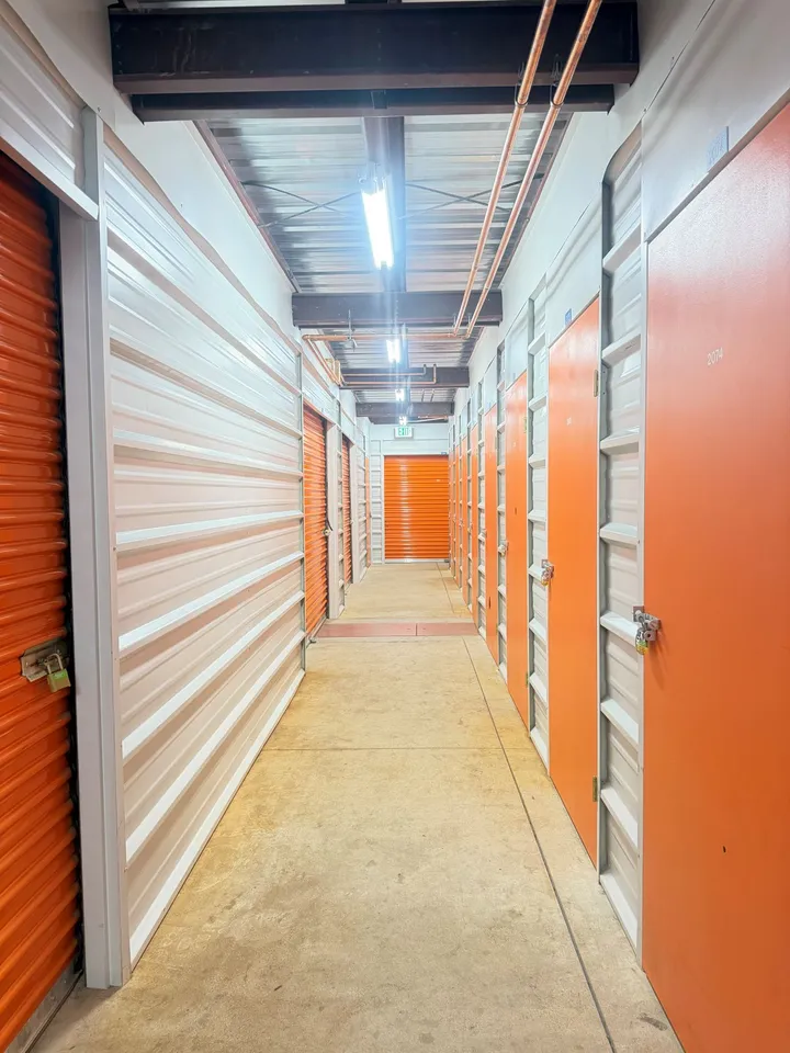 Hallway of indoor storage units in Avon, CO, at 850 Nottingham Rd with red doors