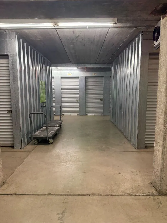 Carts and dollies in a hallway with indoor, secure storage units