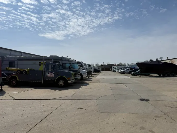Outdoor vehicle storage in Arlington Heights, featuring RVs, trailers, boats, cars, and commercial vehicles