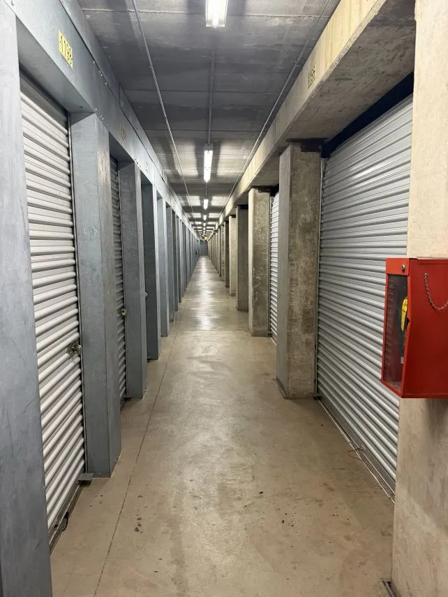 A hallway of indoor storage units