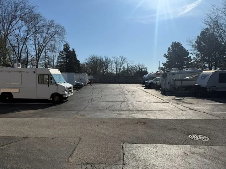 Outdoor vehicle storage in West Chicago depicting various trailers, campers, cars, and commercial vehicles