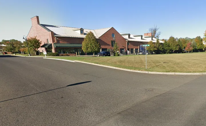 Storage Star in Freehold, NJ, with a drive aisle and green lawn under a clear sky