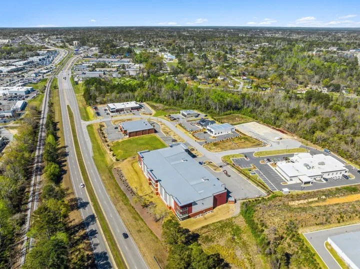 Aerial view of a multi-story self-storage building situated next to a highway and railroad tracks at Storage Star Self-Storage in Augusta on Cooper Dr