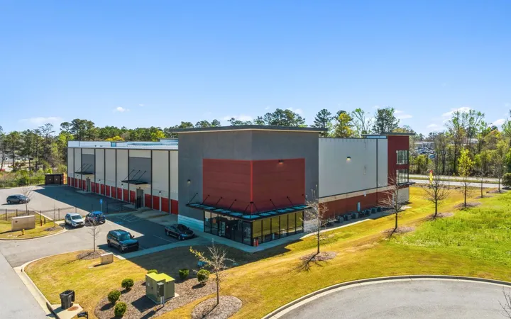Exterior of a multi-story storage building with a glass storefront office, loading bays, and a parking lot at Storage Star Self-Storage in Augusta, GA
