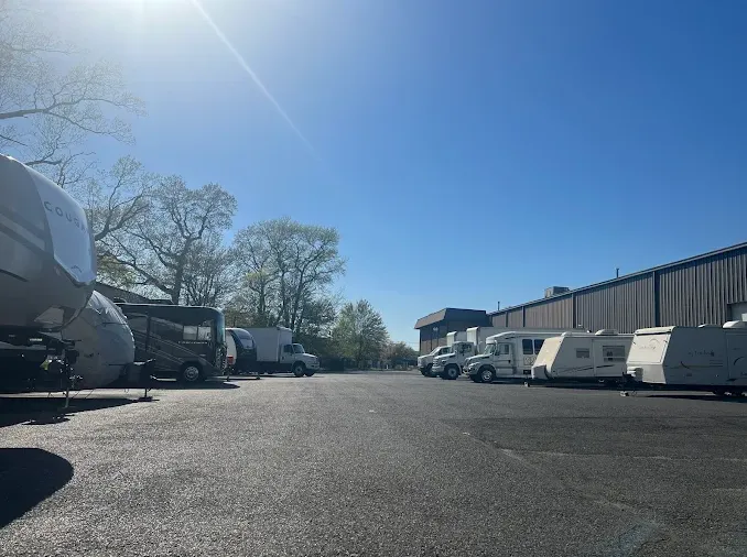 Outdoor storage lot with paved ground featuring RV and vehicle parking storage solutions