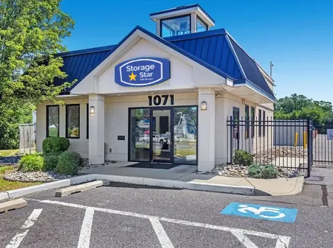 Exterior of a Storage Star storage facility in Westville, NJ, with a glass door and paved parking lot