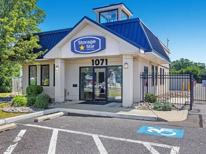 Exterior of a Storage Star storage facility in Westville, NJ, with a glass door and paved parking lot