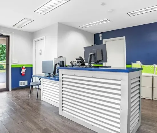 Interior of the rental office at Storage Start Self-Storage in Schenectady, showing a service counter with computers and a fire extinguisher on the wall