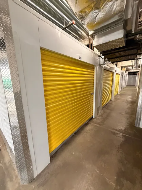 Bright indoor climate-controlled storage in Chicago on N McCormick Blvd with yellow roll-up doors and concrete floors