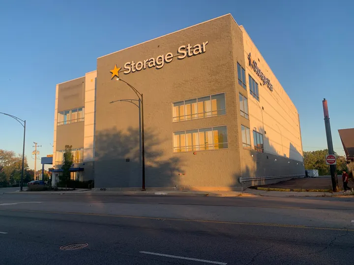 Multi-story gray Storage Star facility in Chicago, IL, on N McCormick Blvd with large windows and a street light in the foreground