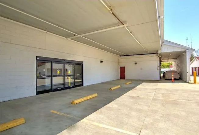 Covered loading area with parking spaces