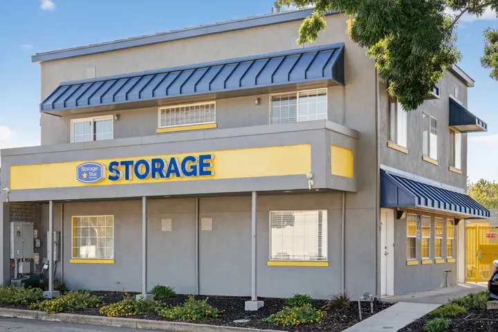 Gray exterior of the rental office at Storage Star Self-Storage in Vacaville, CA, featuring blue signage, windows, and a blue metal awning