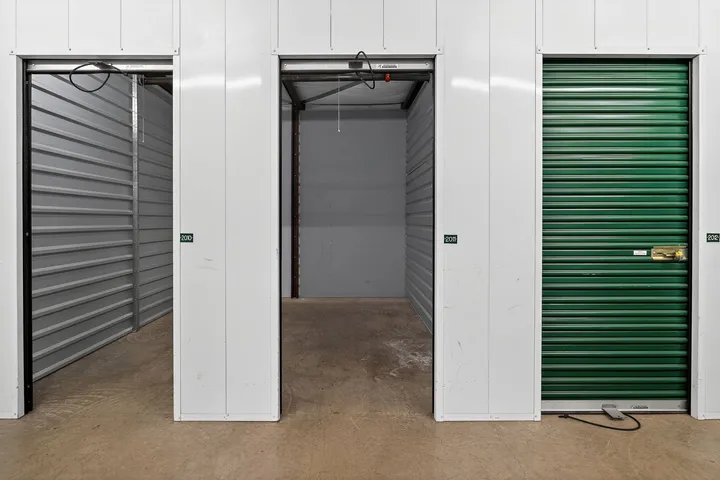 An open indoor storage unit in Vacaville on Bella Vista Rd with a concrete floor between two white hallway walls