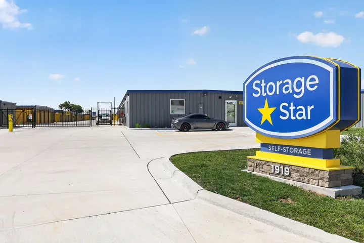 Paved driveway leading to the office at Storage Star in Cheyenne, WY, at 1919 Wyott Dr, with a gated entrance and blue monument sign