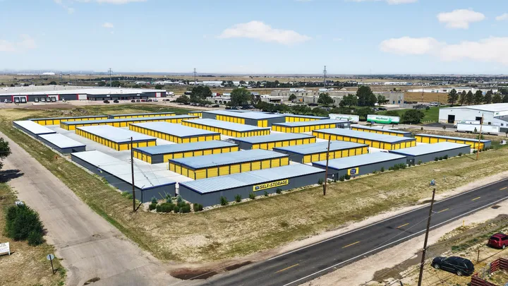 Aerial view of Storage Star Self-Storage in Cheyenne on Wyott Drive, featuring drive-up storage buildings with yellow doors and gray siding along a paved road