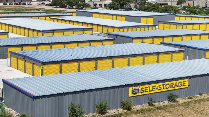 High-angle view of Storage Star Self-Storage in Cheyenne at 1919 Wyott Drive, featuring drive-up storage buildings with gray siding and bright yellow roll-up doors