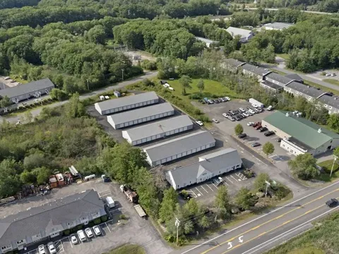 High angle aerial view of Storage Star self-storage buildings in York, ME, with white exteriors and grey roofs