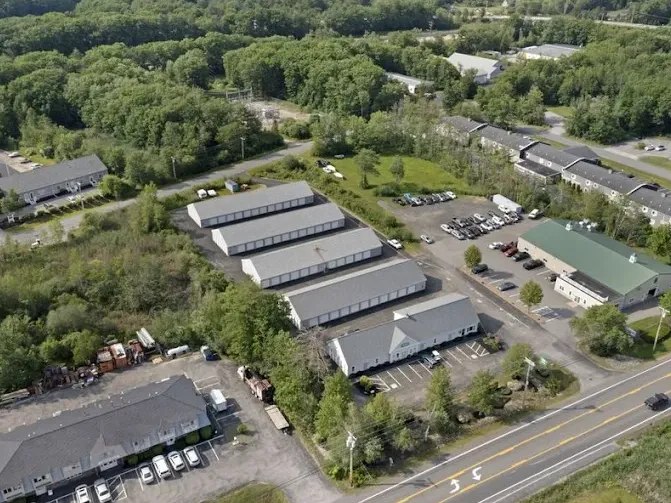 High angle aerial view of Storage Star self-storage buildings in York, ME, with white exteriors and grey roofs