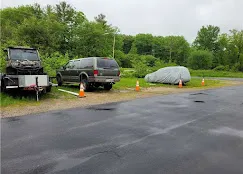 Outdoor vehicle storage in York, ME, featuring a trailer, an SUV, and a car