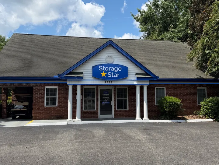 Storage Star leasing office in Aiken, SC on Whiskey Rd with brick walls, white columns, and a blue sign above the door