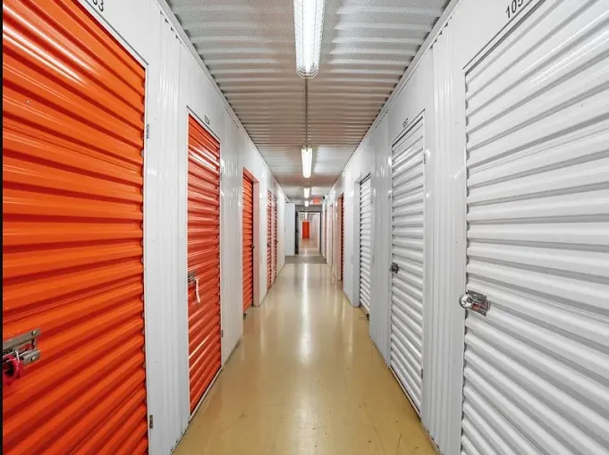 Indoor climate-controlled storage units at Storage Star in Edison, featuring rows of orange and white corrugated roll-up doors