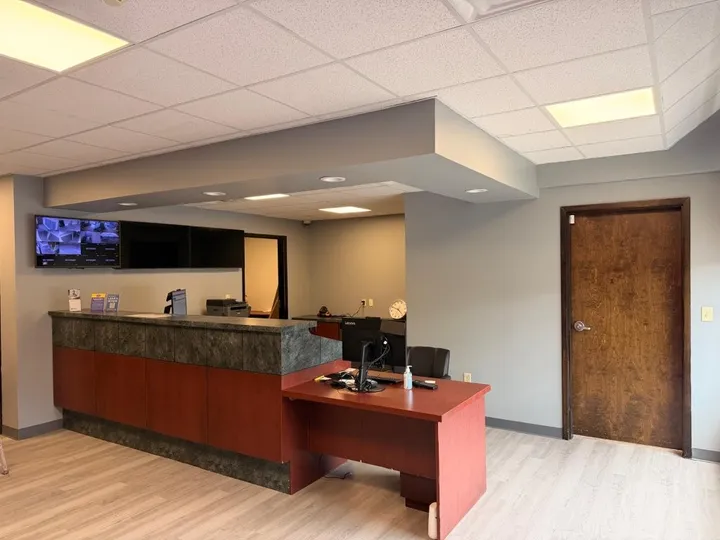 Facility leasing office at Storage Star Self-Storage in Coventry, RI, with a front desk, security monitors, wood floors, and wooden doors