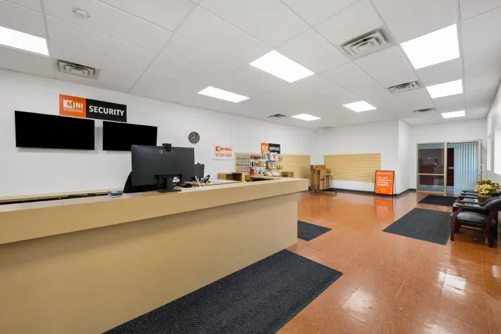 Storage facility leasing office featuring a service counter, computer monitor, and moving supplies for sale