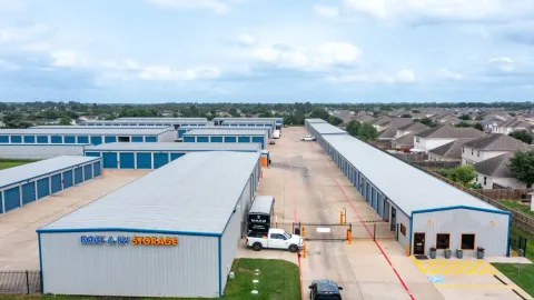 High-angle view of a Boat and RV Storage facility perimeter fence and many drive-up units outdoors