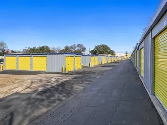 Long row of outdoor drive-up storage units.