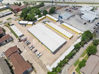 Aerial view showcasing layout of storage buildings and parking.