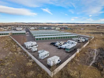 RV and boat storage area with storage units in background